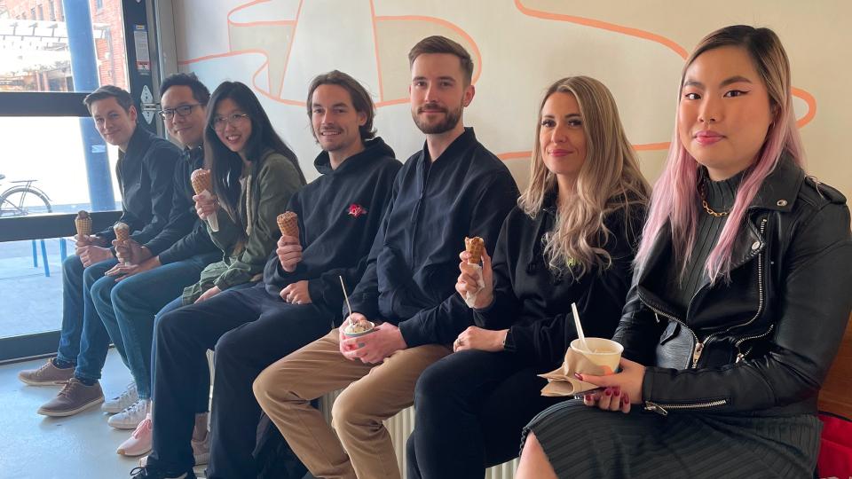 A group of Upanup employees posing while enjoying icecream.