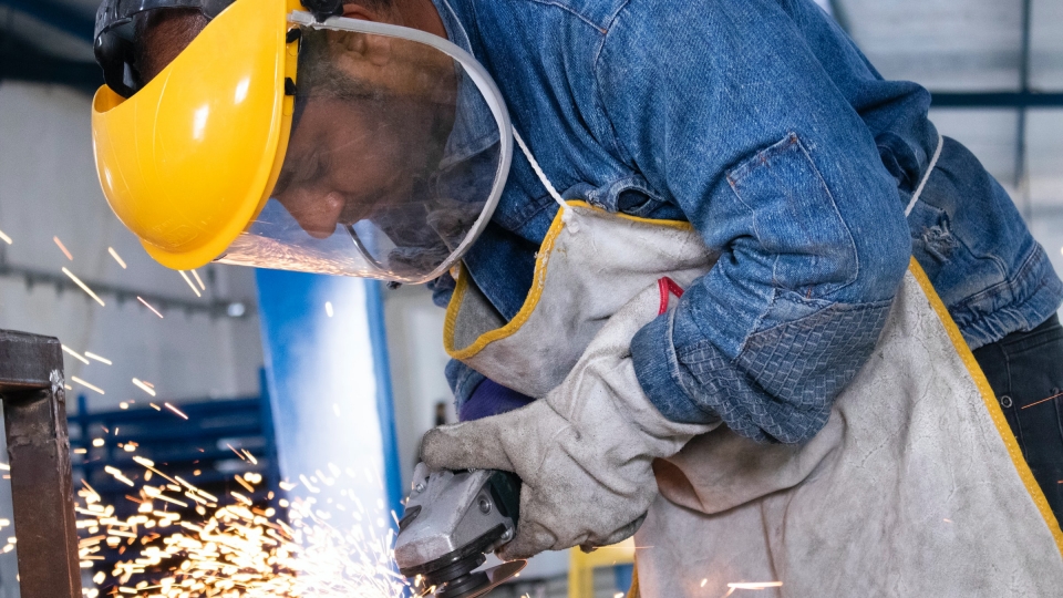 Man using a tool in a factory.
