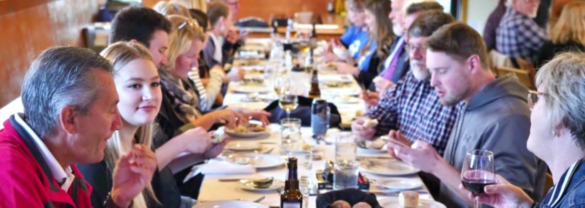 Family eating at long table